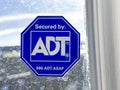 An ADT security sign on a window Royalty Free Stock Photo