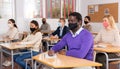 Adult aframerican man in protective mask during lesson in extension school Royalty Free Stock Photo
