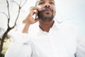 Adult african american male in sun glasses with mobile phone in city garden park. Black and white Royalty Free Stock Photo