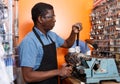 Adult man making key copies on bench machine Royalty Free Stock Photo