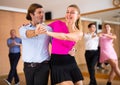 Adult amateur dancers pair practicing swing in dance class Royalty Free Stock Photo