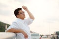 Adult Asian Fat man in white shirt feeling despondent from hard work be finding relaxing and meditation by make calm on the side Royalty Free Stock Photo