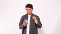 Happy Asian man smiling while holding blank credit card and mobile phone Royalty Free Stock Photo