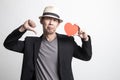 Adult Asian man thumbs down with red heart Royalty Free Stock Photo