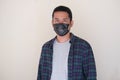 Adult Asian man wearing black medical mask