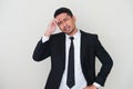 Adult Asian man wearing black suit and tie showing sad expression Royalty Free Stock Photo