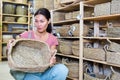 Woman electing wicker basket in housewares store