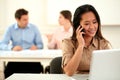 Adult asiatic woman conversing on her cellphone Royalty Free Stock Photo