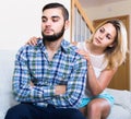 Adult asking offended partner for forgiveness at home