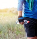 adult athlete is standing in the middle of nature in a blue uniform with a green towel Royalty Free Stock Photo