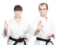 Adult athletes with black belts are doing block Shuto-uke