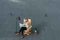 adult bearded businessman sitting in armchair and reading newspaper Royalty Free Stock Photo