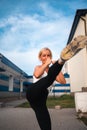Adult beautiful blonde woman doing box kicks exercises workout outdoors, boxing fighting class. Healthy lifestyle, self Royalty Free Stock Photo