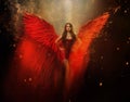 An adult beautiful fantasy girl a fallen angel with spread huge red wings. Art black background with sparks, glitters Royalty Free Stock Photo