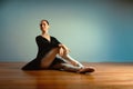 Adult beautiful woman 45-55 years old, ballerina in pointe shoes sits on the floor and poses for the camera. Active old Royalty Free Stock Photo