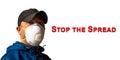 An adult male worker is wearing an N95 respirator mask with the message STOP THE SPREAD in red text