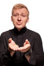 Young blond man in a black shirt, watches and bracelet is making faces, isolated on a white background Royalty Free Stock Photo