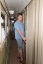 An adult blond man in the train car opens the door Royalty Free Stock Photo