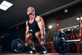 Bodybuilder muscular man doing heavy deadlift exercise with weight while in gym over dark background Royalty Free Stock Photo