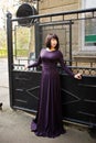 Adult brunette woman at violet gown Royalty Free Stock Photo