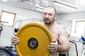 The adult brutal man is engaged in power bodybuilding