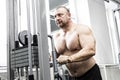 The adult brutal man is engaged in power bodybuilding