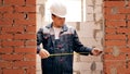 Adult building measuring width of doorway Royalty Free Stock Photo