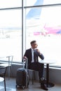 adult businessman with travel bag sitting at table