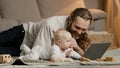 Adult caucasian dad bearded single father with newborn baby making video call to mother or relatives indoors daddy with Royalty Free Stock Photo