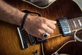 Adult caucasian guitarist portrait playing electric guitar on grunge background. Close up instrument detail. Music