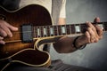 Adult caucasian guitarist portrait playing electric guitar on grunge background. Close up instrument detail. Music Royalty Free Stock Photo