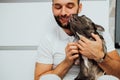 Adult Caucasian Man Hugging His Lovely Pet, French Bulldog Licks Its Owner