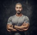 Adult caucasian muscular bodybuilder showing his muscles and looking calm on camera, portrait look Royalty Free Stock Photo