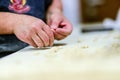 Adult caucasian woman preparing pisarei, italian extruded traditional pasta from Piacenza, Italy