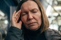 Adult caucasian woman with severe migraine headache riding the public transportation bus at night Royalty Free Stock Photo