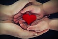 Adult and child hands holding red heart, health care, donate and family insurance concept,world heart day, world health day, CSR c Royalty Free Stock Photo