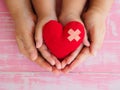 Adult and child hands holding red heart, health care, love, orga Royalty Free Stock Photo