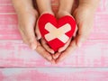 Adult and child hands holding red heart, health care, love, orga Royalty Free Stock Photo