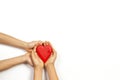 Adult and child hands holding red heart over white background. Love, healthcare, family, insurance, donation concept Royalty Free Stock Photo