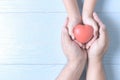 Adult and child hands holding red heart on vintage Royalty Free Stock Photo