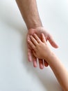 Adult and child hold their hands together. Fathers Day Child gives hand to adult Royalty Free Stock Photo