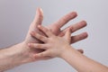 Adult and child's hand touching help tenderness