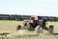 Fun remote control 4x4 all terrain cart on sunny day on gravel.