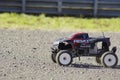 Fun remote control 4x4 all terrain cart on sunny day on gravel.