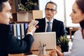 Adult confident man gives money to lawyer for divorce, sitting at office table.