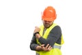 Adult constructor wearing helmet and vest touching elbow