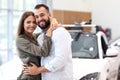 Adult couple choosing new car in showroom Royalty Free Stock Photo