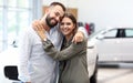 Adult couple choosing new car in showroom Royalty Free Stock Photo