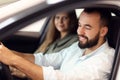 Adult couple choosing new car in showroom Royalty Free Stock Photo