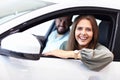 Adult couple choosing new car in showroom Royalty Free Stock Photo